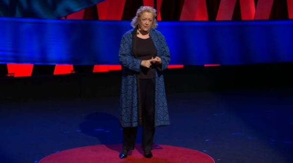 Woman on a TED Talk stage.