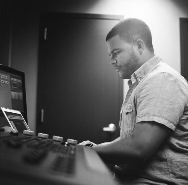 A man in front of a laptop.