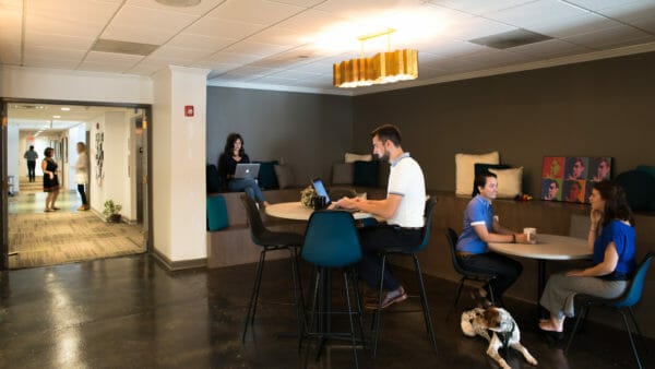 People working in Center 615 common area.