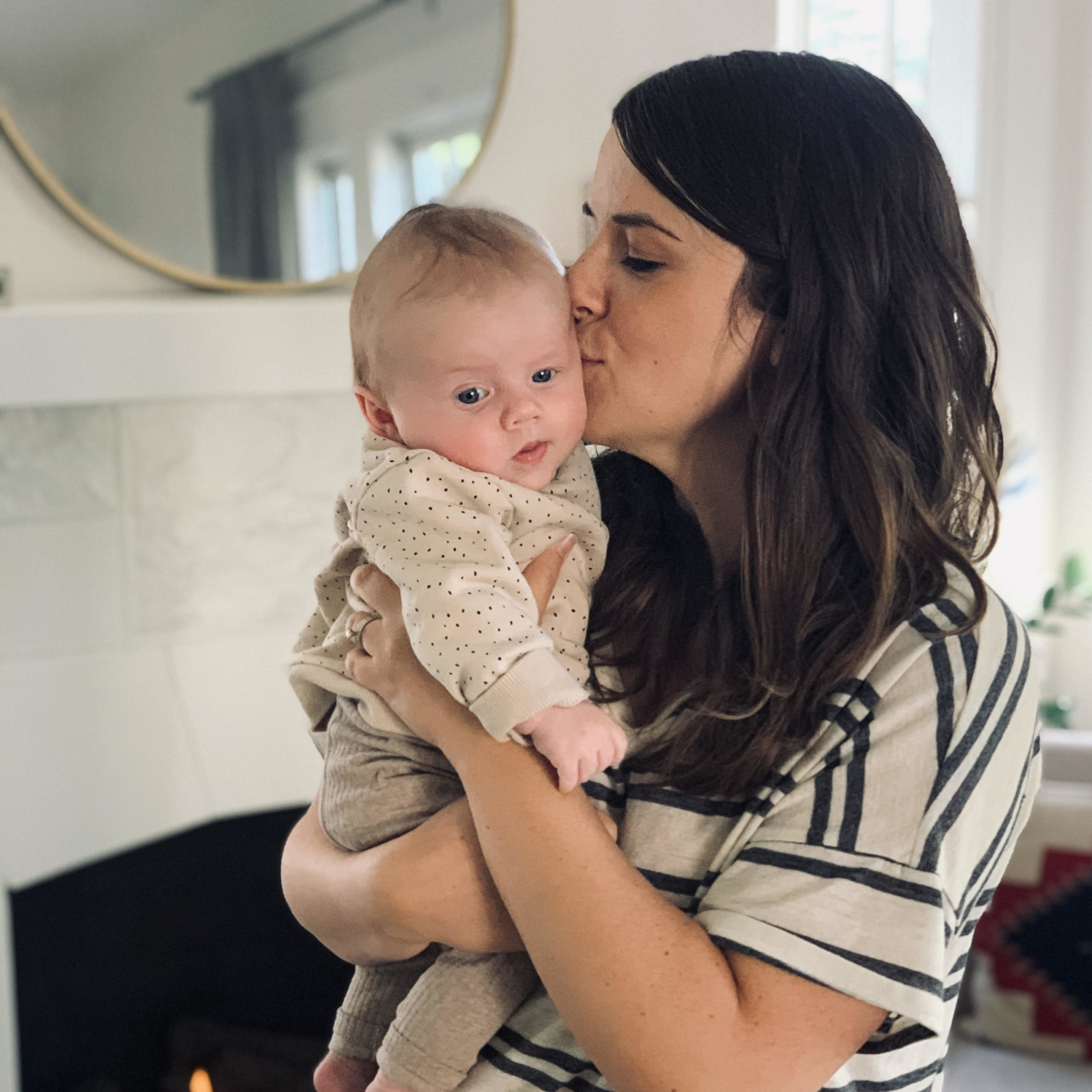 Woman kissing her baby 