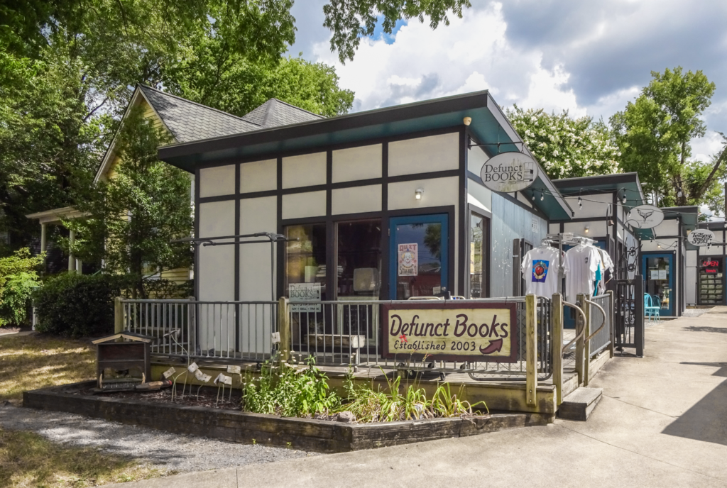 Defunct Books used and rare bookshop in East Nashville facade with trees
