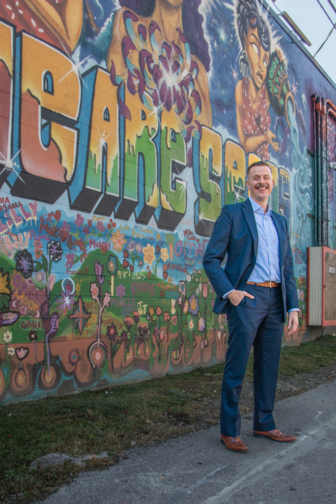 S&S Insurance Nashville agent Taylor Jones in font of We Are Seeds Mural at Center 615