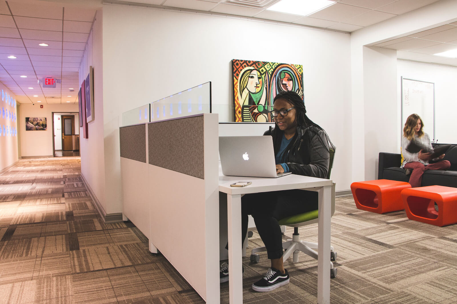 Woman working on her laptop in a coworking space.